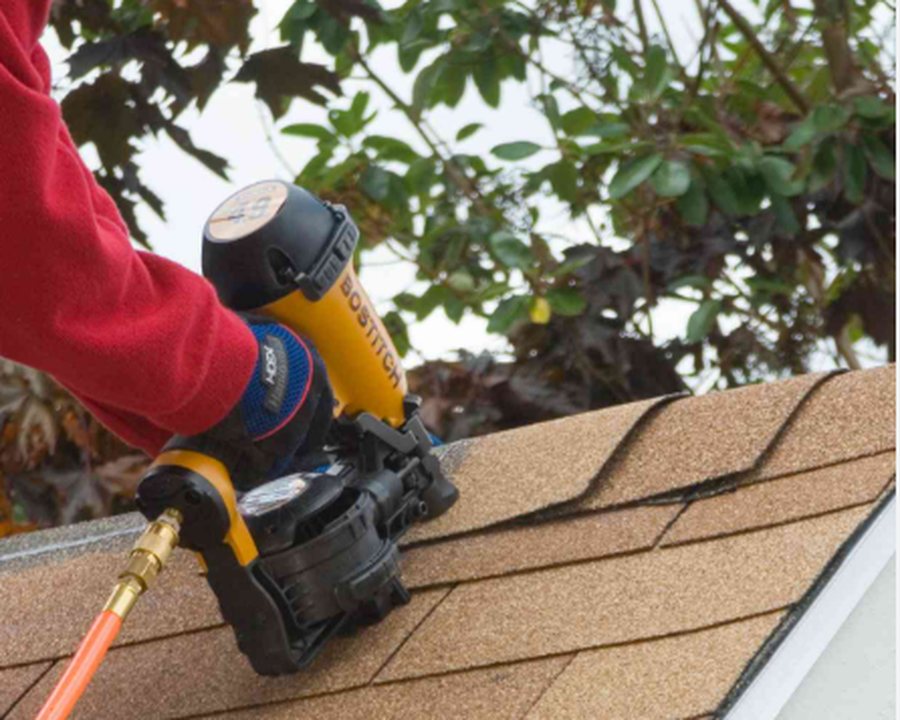 Nailing down 3-tab shingles with a roofing nail gun