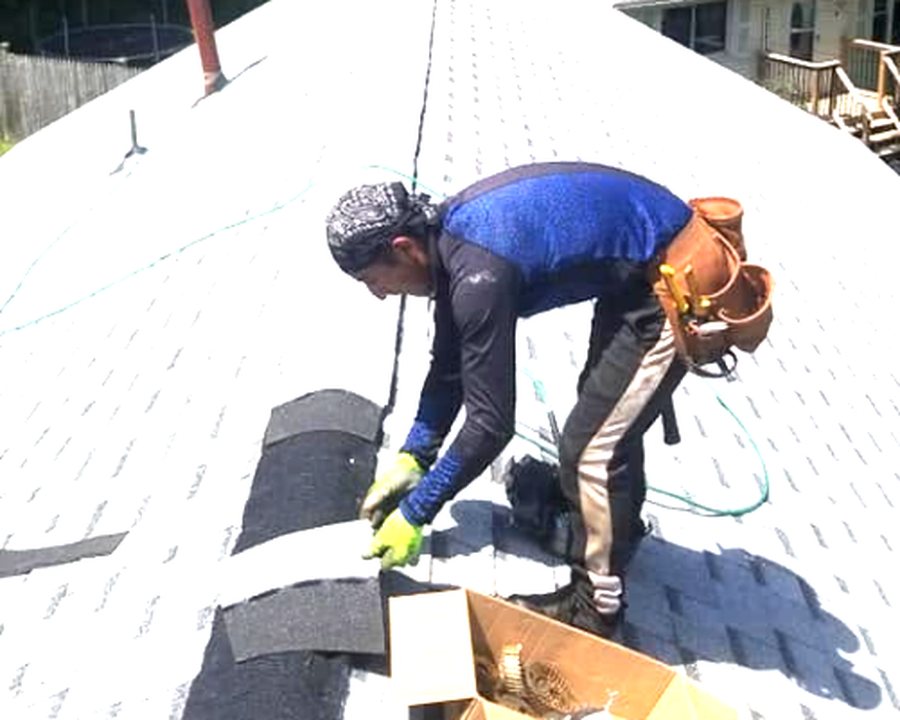 All Phase roofer laying new shingles over fresh underlayment